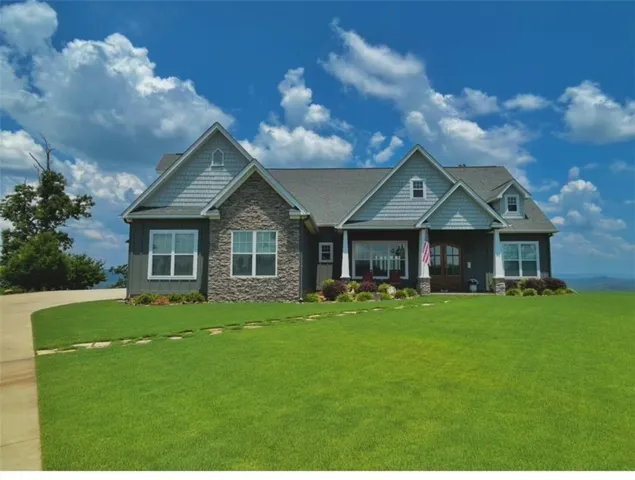 Craftsman-style home featuring a stone and board-and-batten exterior