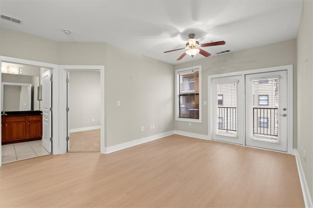Spare room featuring light wood-type flooring and ceiling fan
