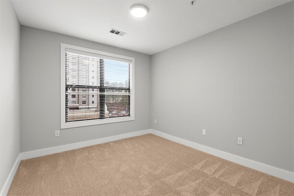 Empty room featuring light colored carpet