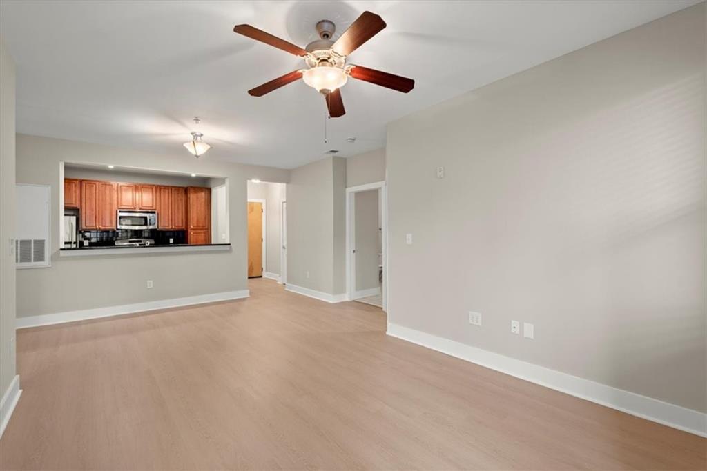 Unfurnished living room featuring light hardwood / wood-style floors and ceiling fan
