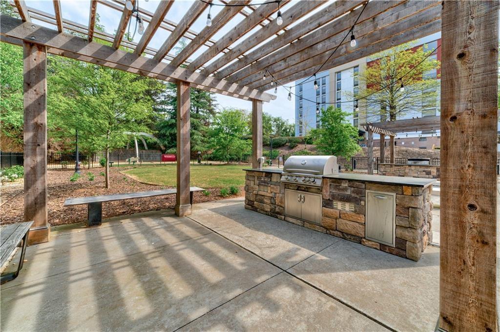 View of patio / terrace with a pergola, a grill, and an outdoor kitchen