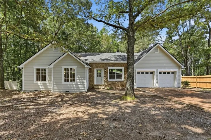 Stone and siding exterior with a gabled roofline