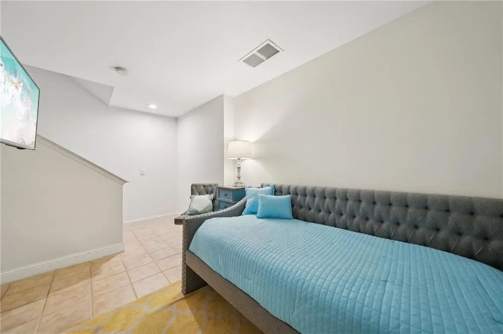 Bedroom with light tile patterned flooring, baseboards, visible vents, and recessed lighting