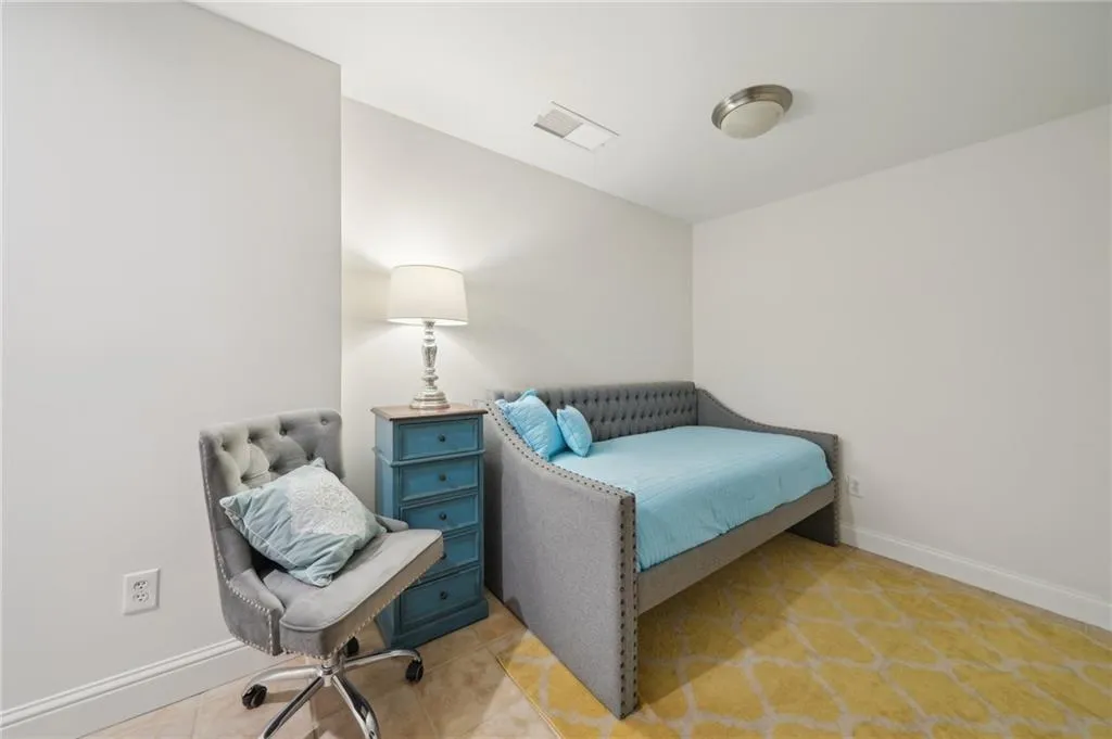 Bedroom with baseboards and visible vents