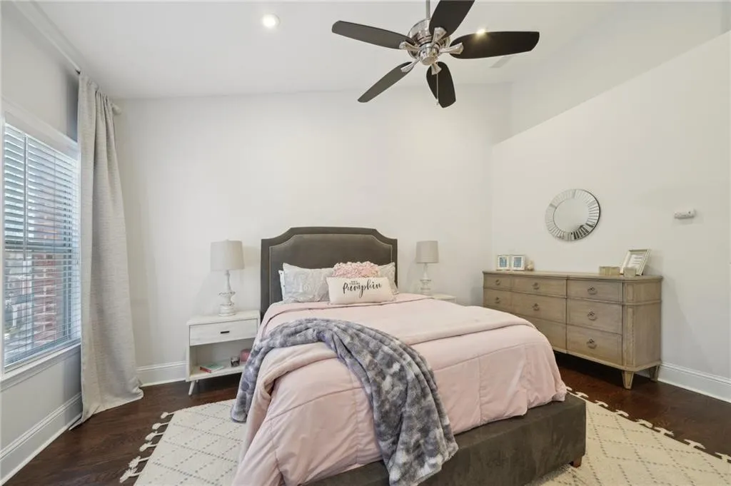Bedroom with baseboards, ceiling fan, wood finished floors, and recessed lighting