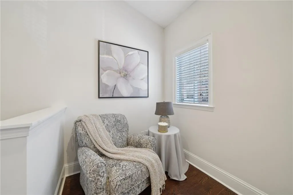 Living area with dark wood-type flooring and baseboards