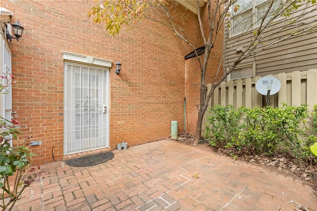 Property entrance with a patio area and brick siding