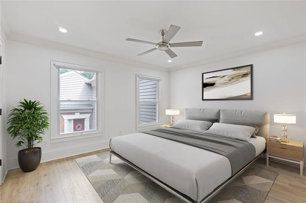 Bedroom with ornamental molding, light wood-type flooring, a ceiling fan, and recessed lighting