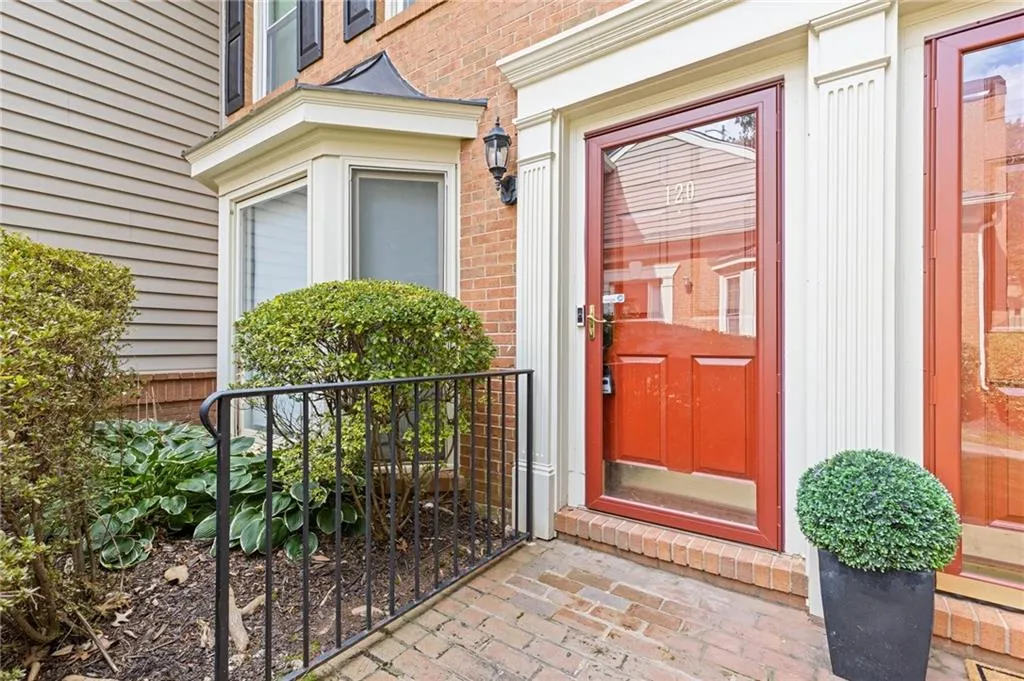 Entrance to property featuring brick siding