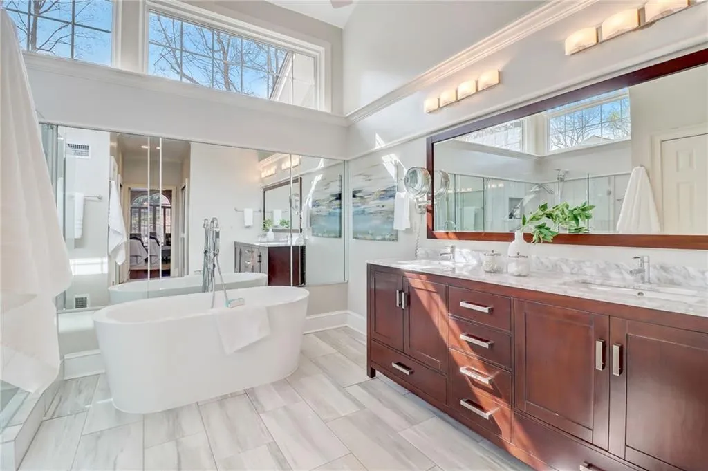 Primary bath vaulted ceiling, double sink vanity, and tub