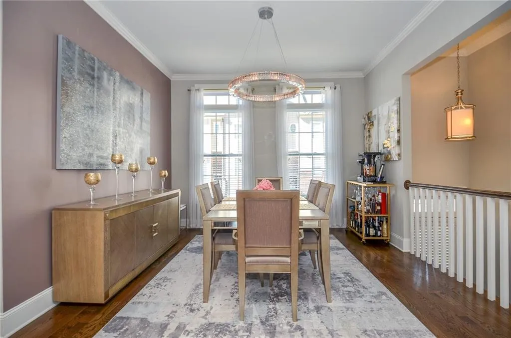 Dining room featuring ornamental molding and dark wood finished floors