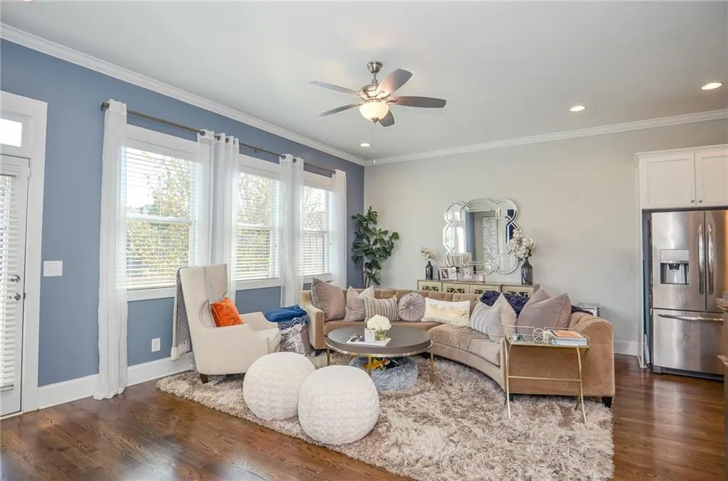 Living room featuring ornamental molding, dark wood-style floors, a ceiling fan, and recessed lighting