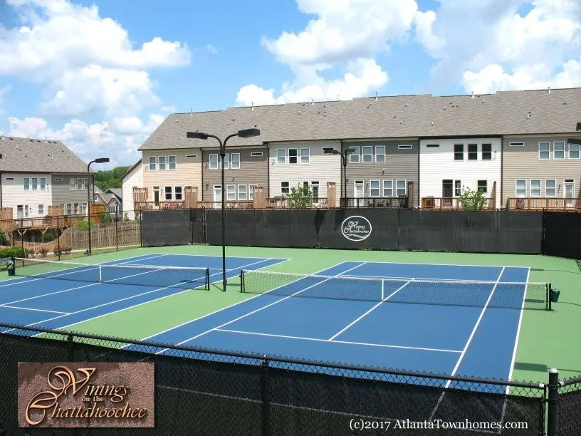 View of tennis court with community basketball court and a residential view