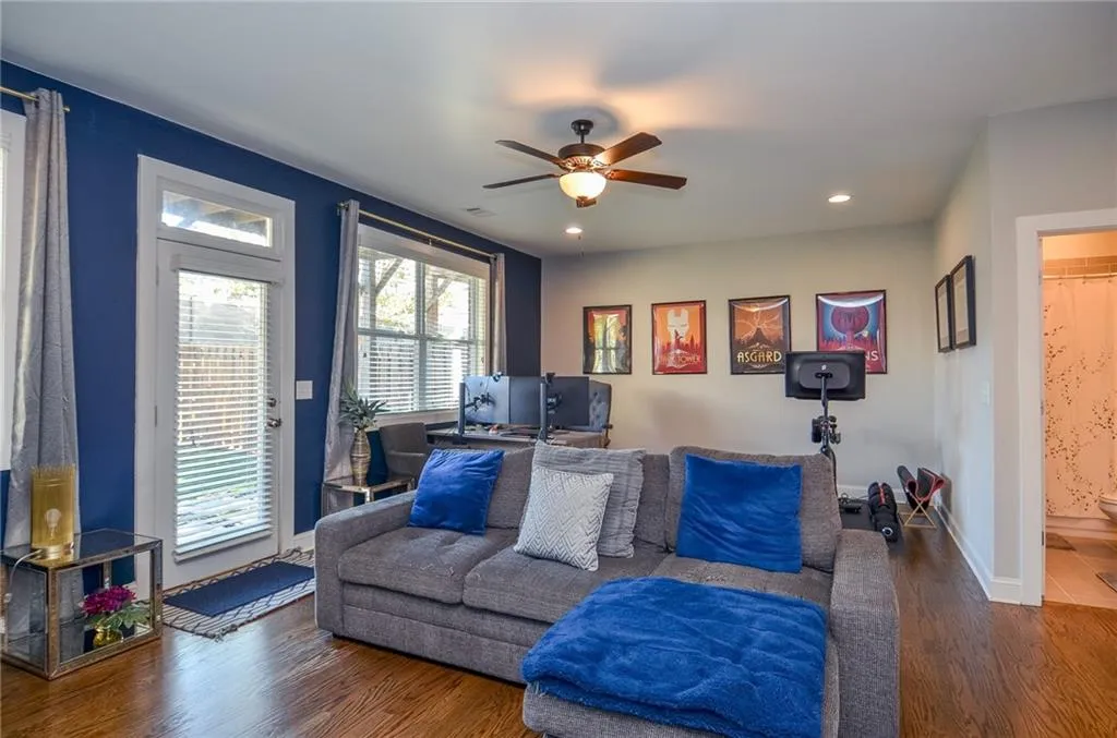 Living area with wood finished floors, a ceiling fan, and recessed lighting