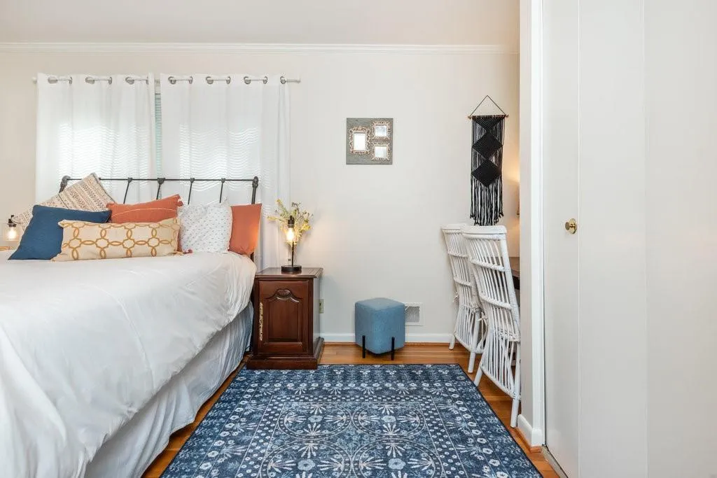 Bedroom with ornamental molding and hardwood / wood-style floors