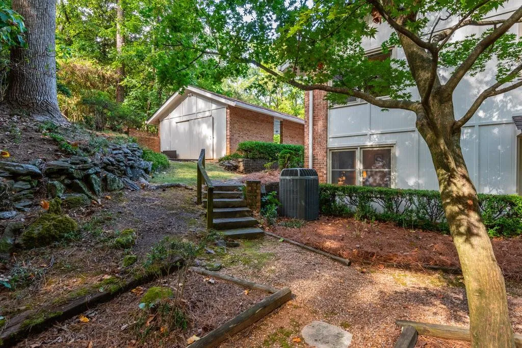 View of yard with central AC unit and a storage unit