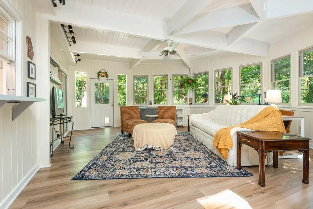 Sunroom / solarium with a wealth of natural light, ceiling fan, and beam ceiling