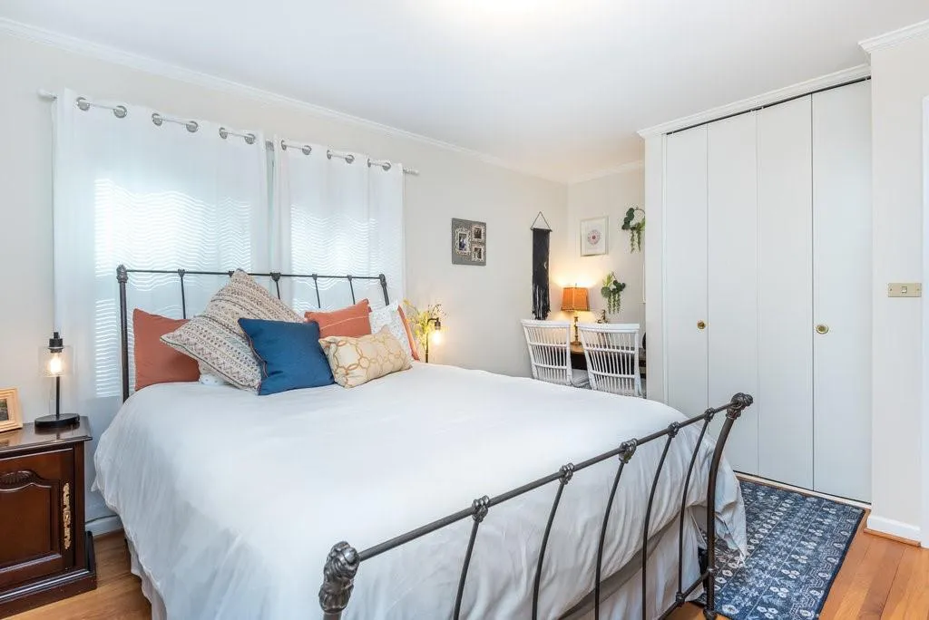 Bedroom featuring a closet, light hardwood / wood-style floors, and ornamental molding