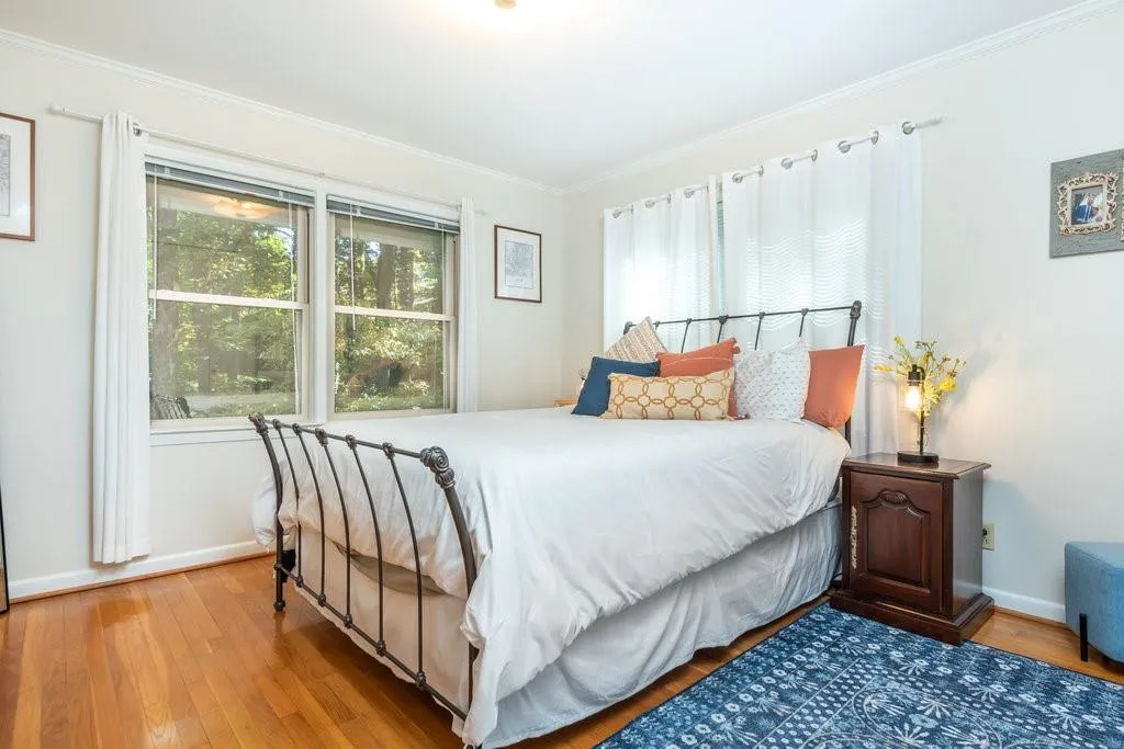 Bedroom featuring ornamental molding and light hardwood / wood-style flooring