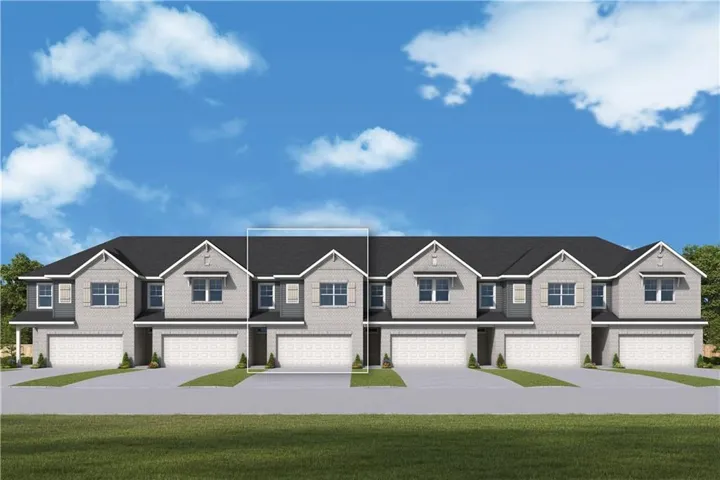 Modern townhome façade featuring light gray brick and horizontal siding accents