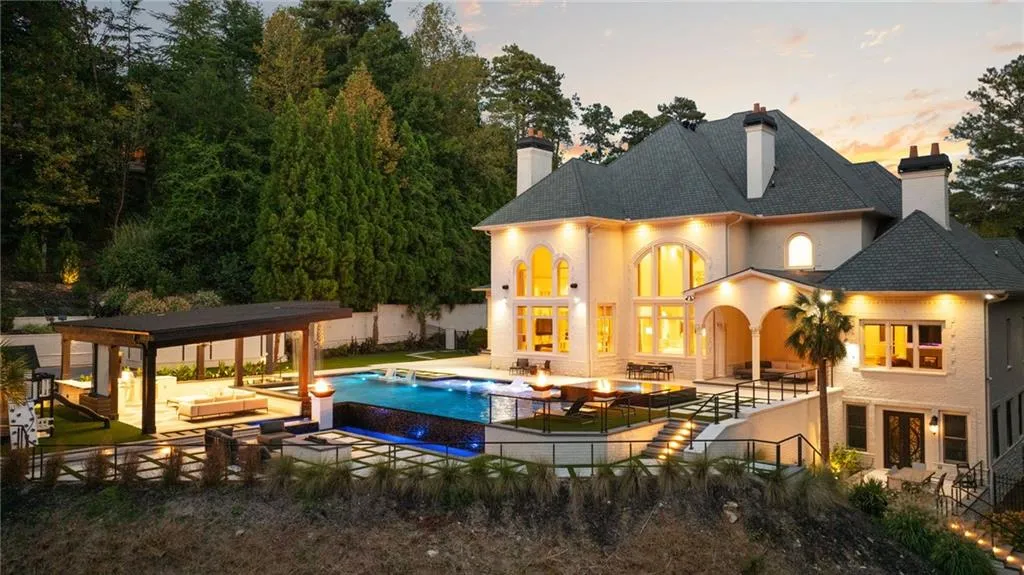 Multi-level exterior with an expansive outdoor entertainment area, infinity-edge pool, and integrated spa