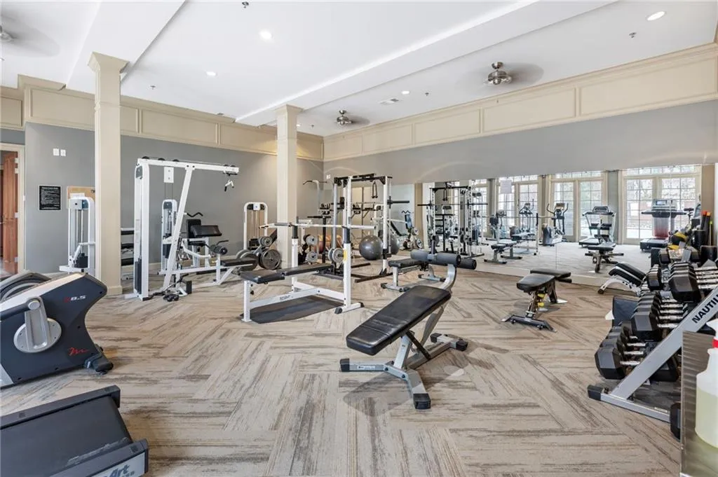 Workout area with ceiling fan and recessed lighting