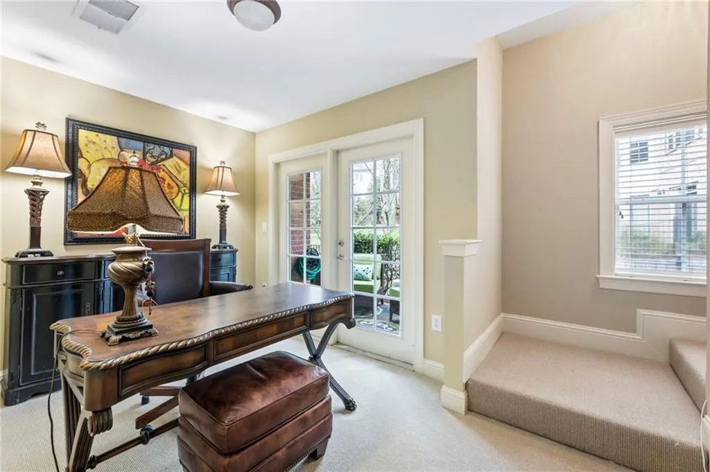 Home office featuring light carpet and french doors