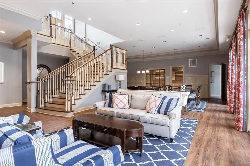 Living room featuring ornamental molding, wood finished floors, and recessed lighting