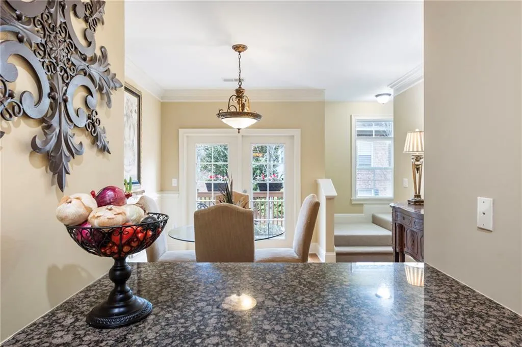 Dining room with crown molding, plenty of natural light, and french doors
