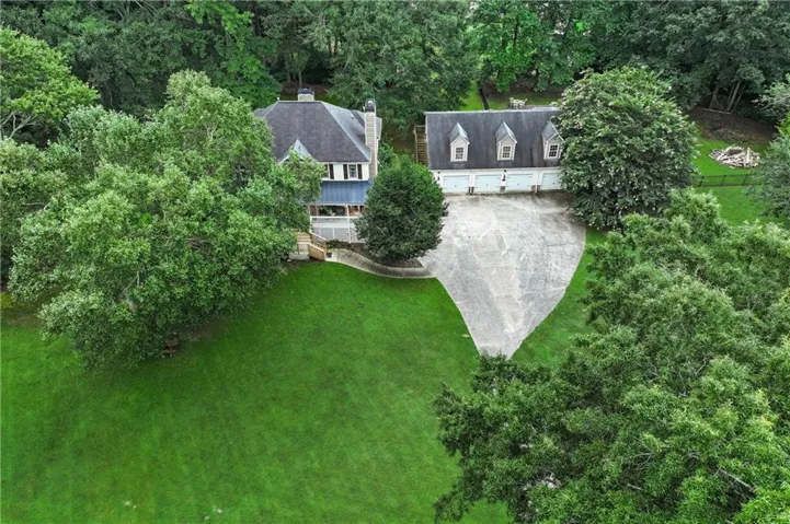 Expansive green lawn surrounds a two-story residence featuring a covered porch