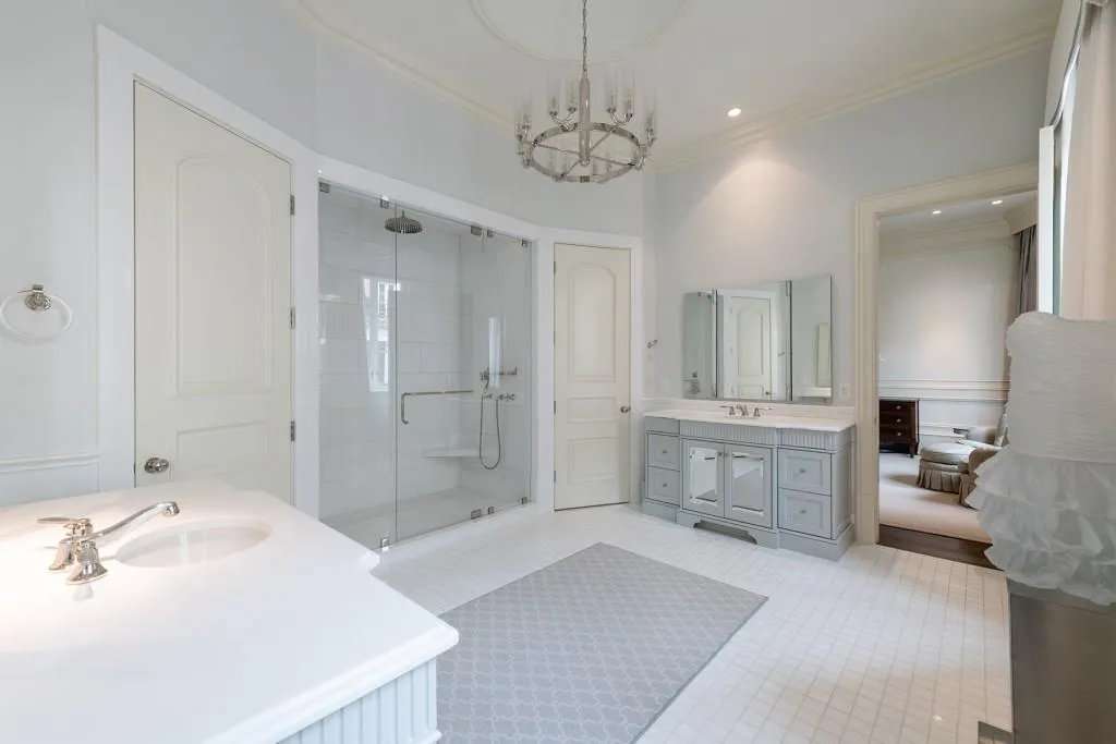 Primary suite bathroom with double water closets and large shower