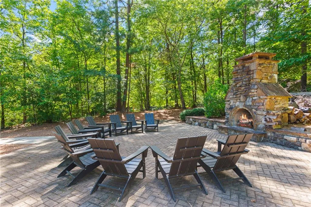 View of patio featuring an outdoor stone fireplace