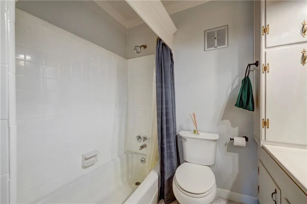 Secondary bath with tile floor and tub surround