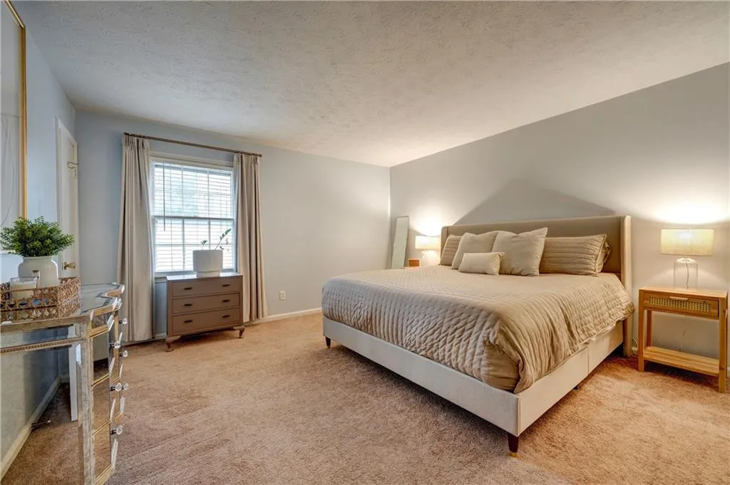 Primary bedroom with light carpet