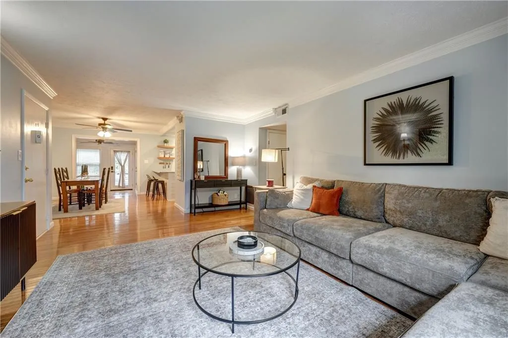 Great room with crown molding and hardwood floors