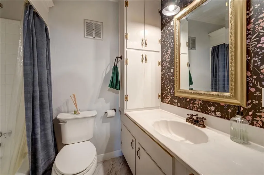 Full bathroom with large vanity and tile floor