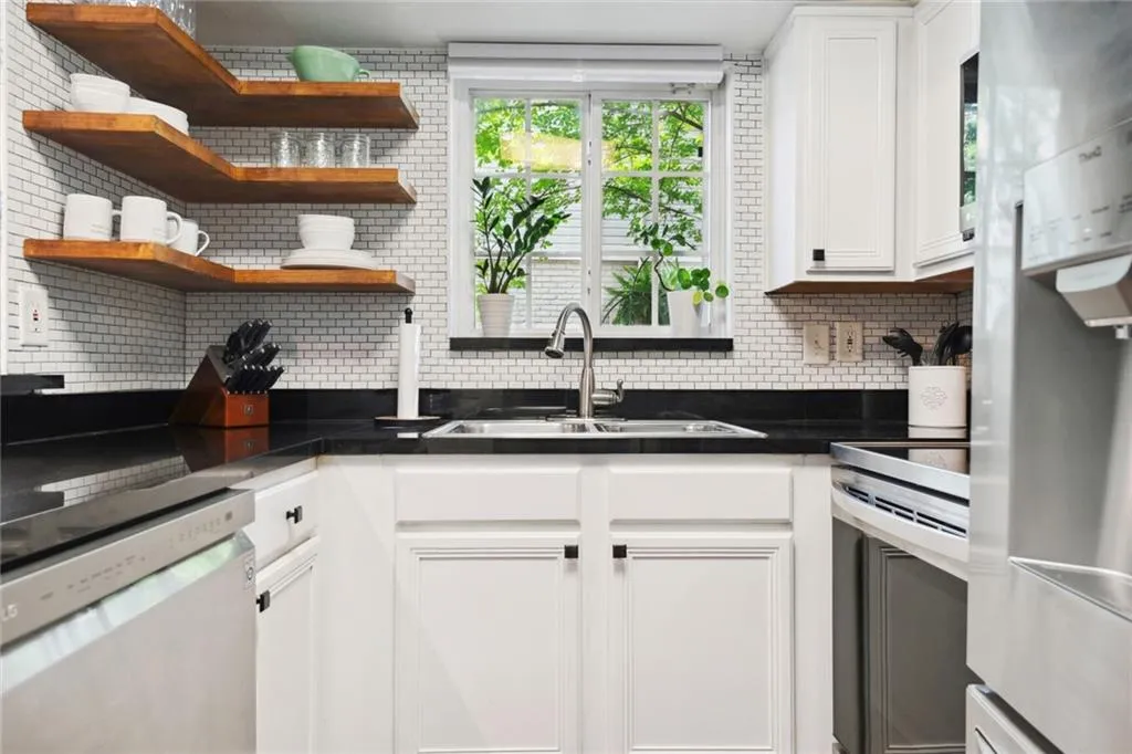 Kitchen featuring white cabinets, white appliances, and sink