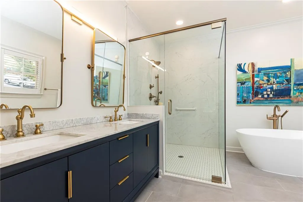 Dual sinks, luxurious shower and soaking tub give this primary bath a spa feel.