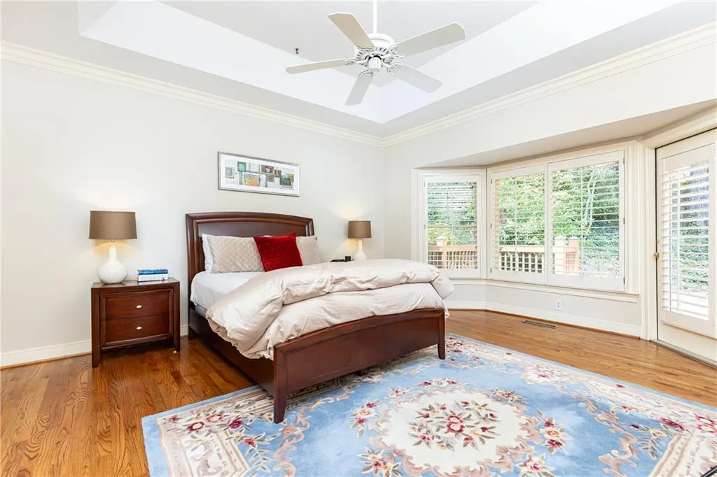 The extra large primary bedroom on the main level with a grand bay window could host a sitting area or reading nook. Open up the door to the patio on fresh fall and spring days.