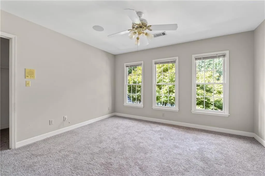 Guest bedroom with walk in closet and new carpet Guest bedroom with walk in closet and new carpet