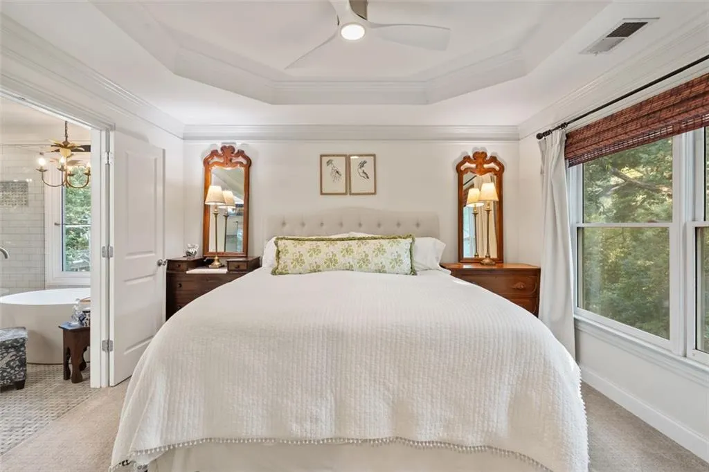 Primary bedroom features double doors into the ensuite bath