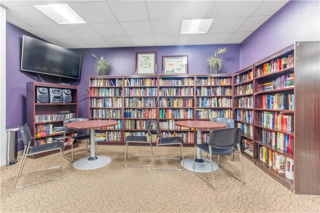 Living area with bookshelves and a drop ceiling