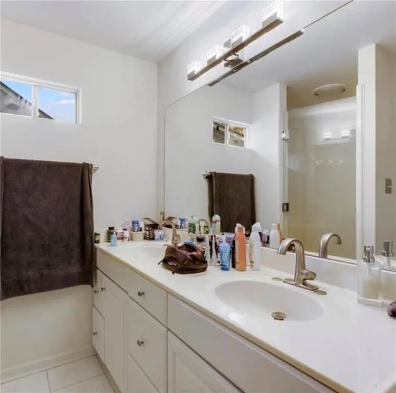 Full bathroom featuring light tile patterned flooring and a stall shower