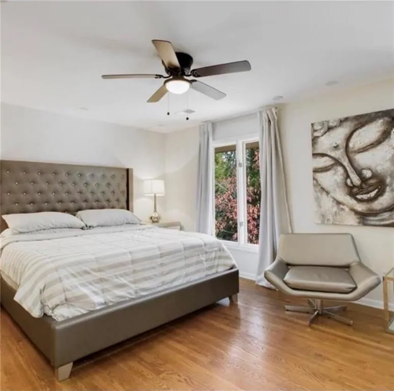 Bedroom with light wood finished floors and ceiling fan