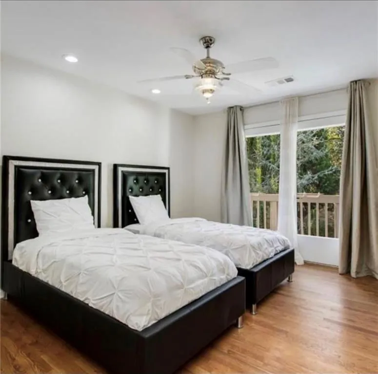 Bedroom with light wood finished floors, recessed lighting, and a ceiling fan