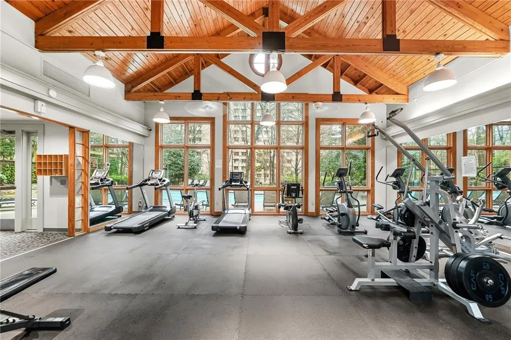 Exercise room featuring a high wood beamed ceiling
