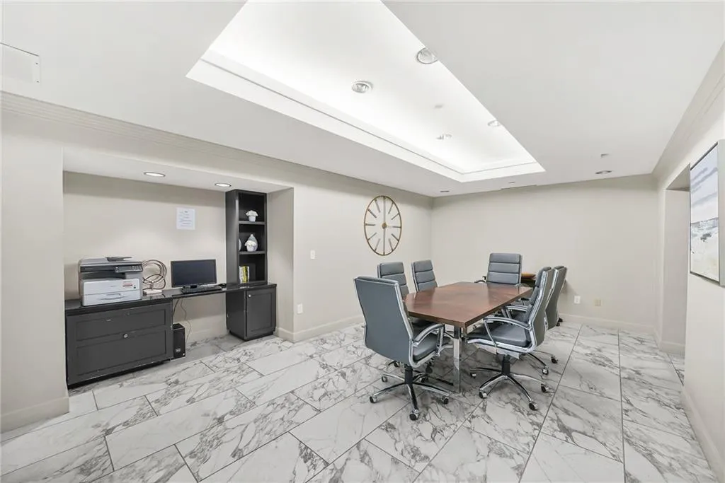 Home office with crown molding, a tray ceiling, and recessed lighting