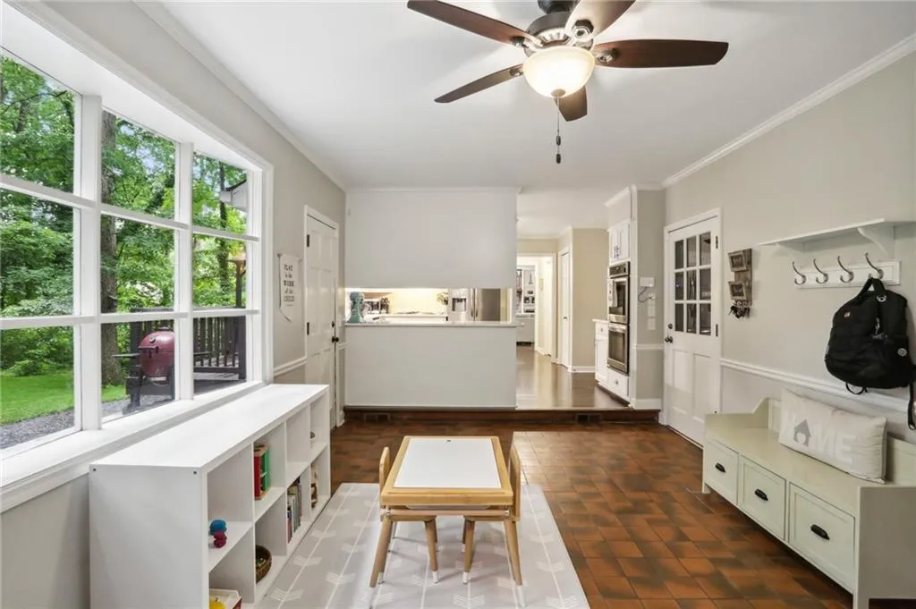 Office space with ornamental molding and ceiling fan