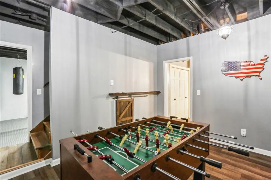 Recreation room featuring dark wood-type flooring