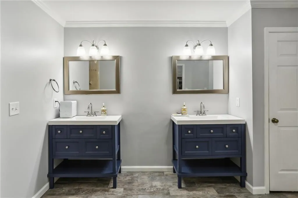 Bathroom with crown molding, hardwood / wood-style flooring, and double sink vanity